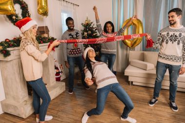 multiethnic friends playing limbo game clipart