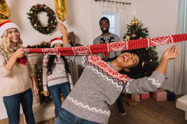 multiethnic friends playing limbo game clipart