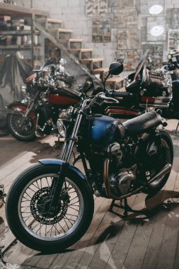 classic motorcycles in workshop clipart