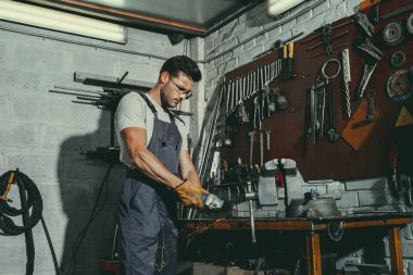 mechanic with tools in workshop