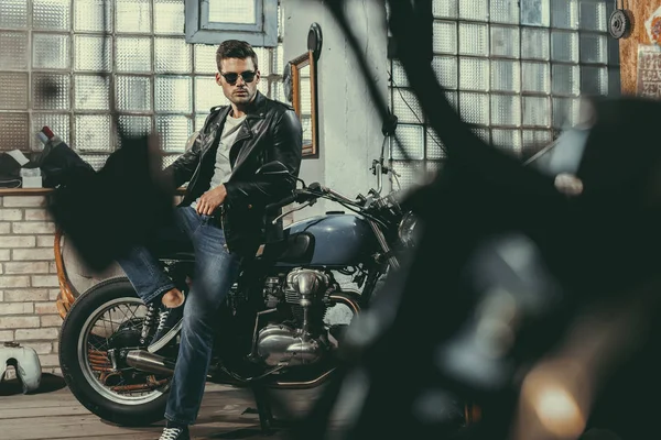 Handsome biker in workshop — Stock Photo, Image