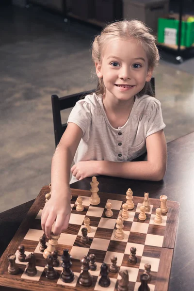 Preschooler child making move in chess — Stock Photo, Image