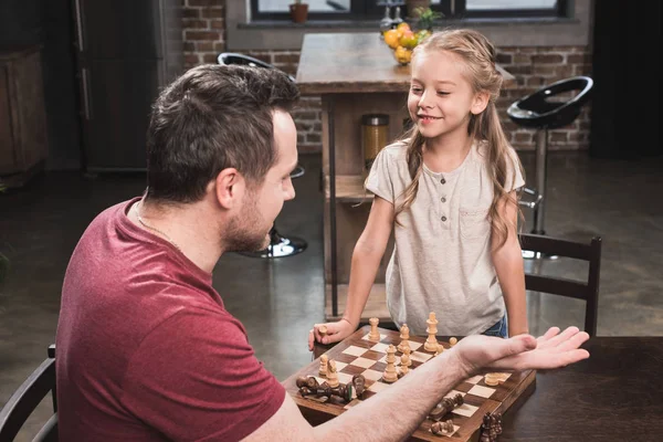 Счастливая дочь после игры в шахматы — стоковое фото