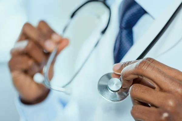 Doctor holding stethoscope in hands — Stock Photo