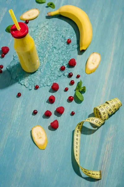 Bottle with smoothie and berries — Stock Photo