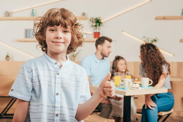 Curly boy showing thumb up — Stock Photo