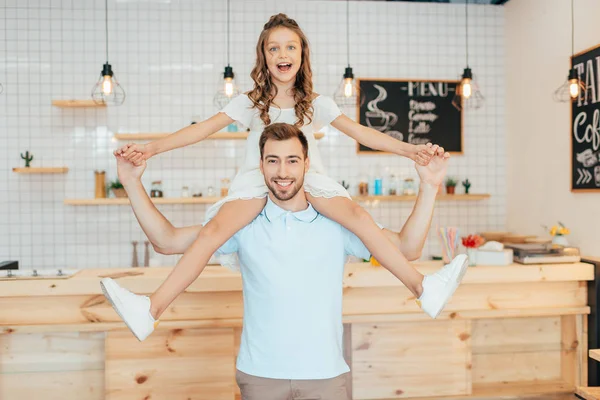 Daughter piggybacking on father — Stock Photo