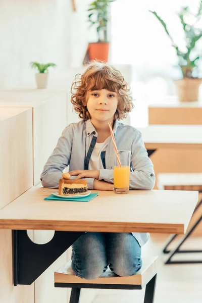 Cheerful curly boy in cafe — Stock Photo