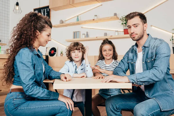 Beautiful young family in cafe — Stock Photo