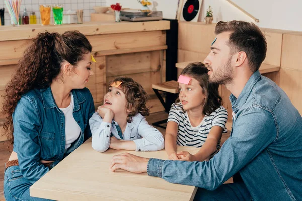 Family playing guess sticker — Stock Photo