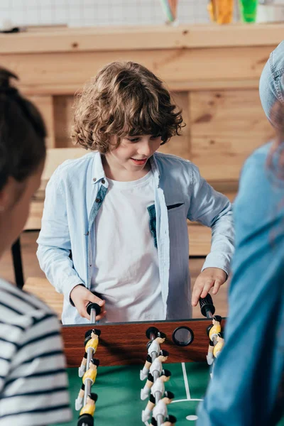 Boy playing table football with family — Stock Photo