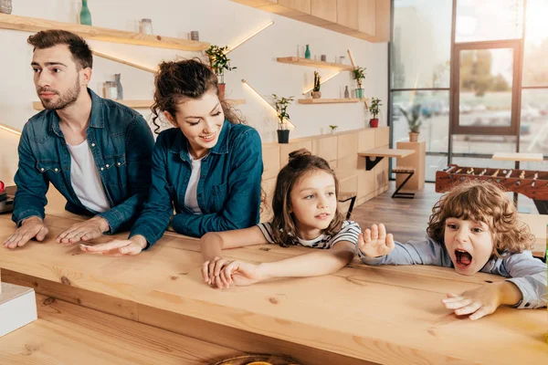 Beautiful young family in restaurant — Stock Photo