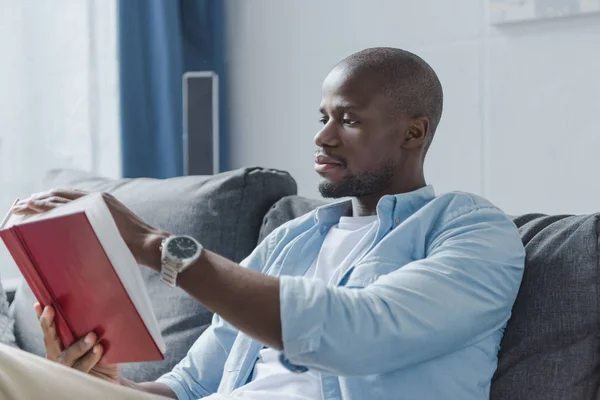 African american man reading book — Stock Photo