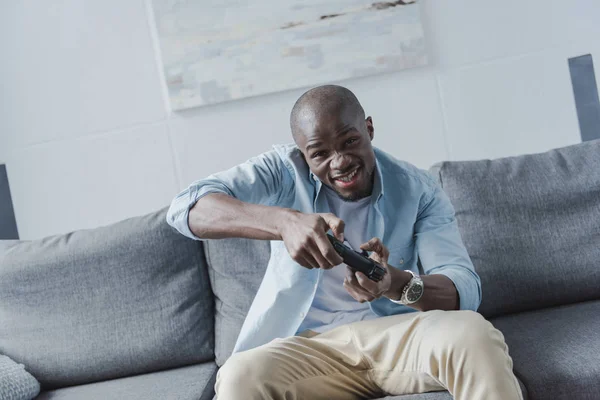 Hombre afroamericano jugando con joystick - foto de stock