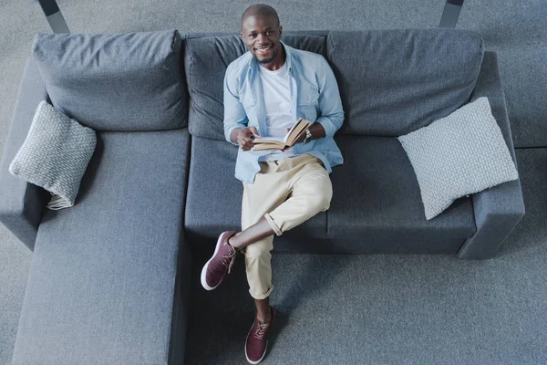 African american man reading book — Stock Photo