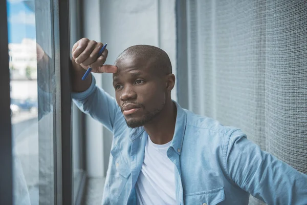 African american man looking at window — Stock Photo