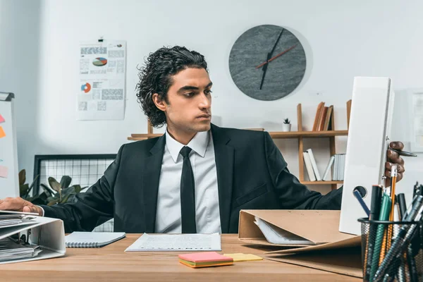 Businessman working with papers at workplace — Stock Photo