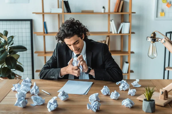 Сердитий бізнесмен стискає папери на робочому місці — Stock Photo