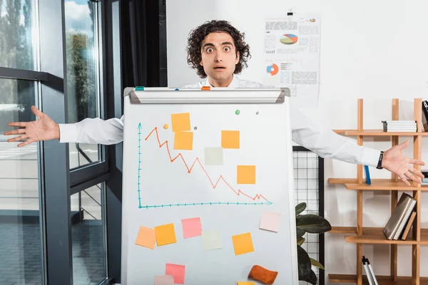 Businessman near white board in office — Stock Photo