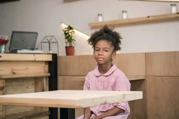 Girl sitting alone in cafe — Stock Photo