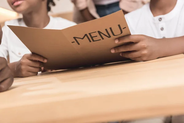 Kids holding menu list — Stock Photo