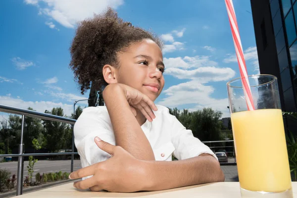 Afro girl with orange juice — Stock Photo