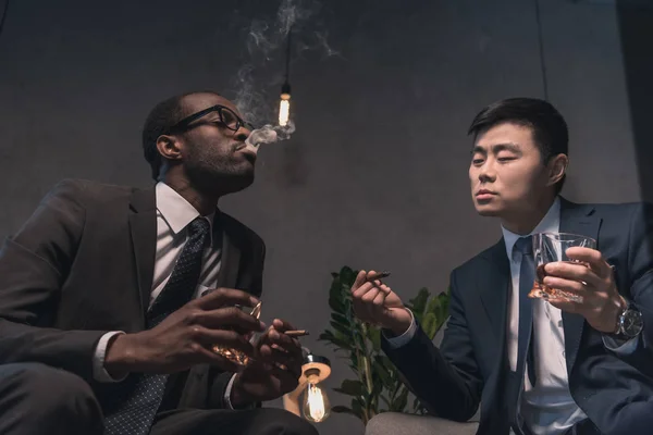 Multiethic businessmen relaxing on armchairs — Stock Photo