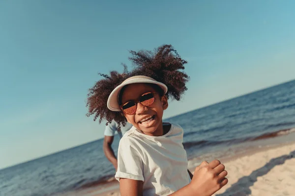 Bambino afroamericano che corre sulla spiaggia — Foto stock