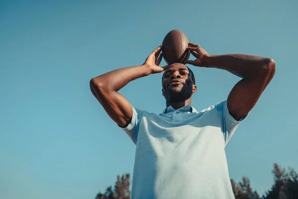 Homem americano africano com bola de rugby — Fotografia de Stock