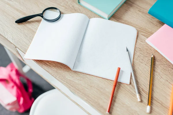 Writing desk with school supplies — Stock Photo