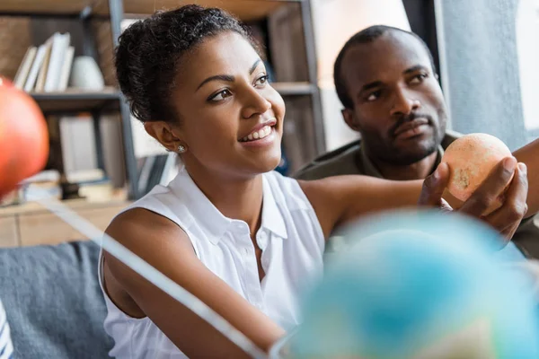 Woman holding little planet figurine — Stock Photo