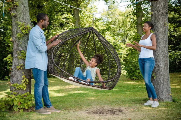 African american family on swing — Stock Photo