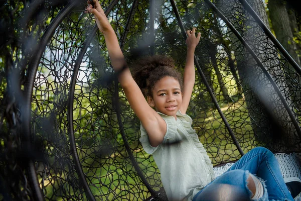 Kid swinging on swing in park — Stock Photo