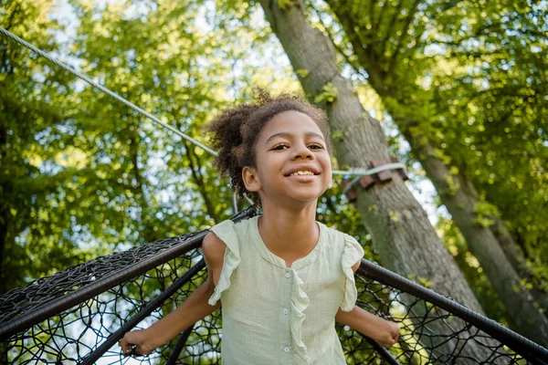 Kid swinging on swing in park — Stock Photo