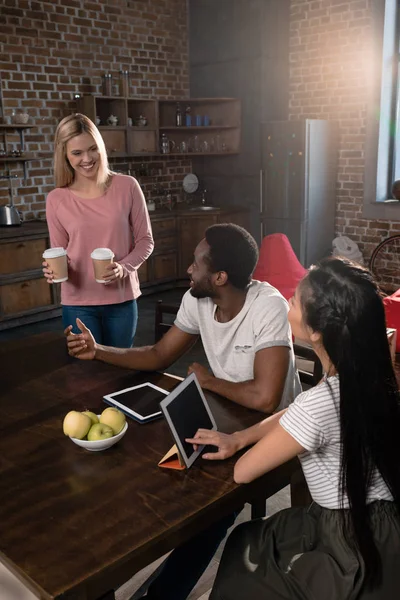 Disposable cups of coffee on kitchen — Stock Photo