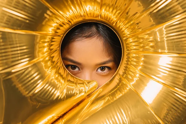 Woman looking through balloon — Stock Photo