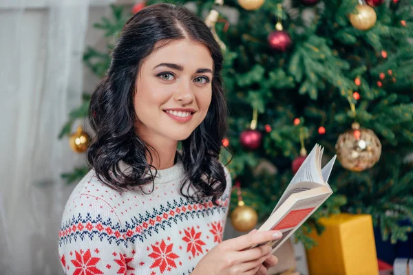 Woman reading book on christmas — Stock Photo