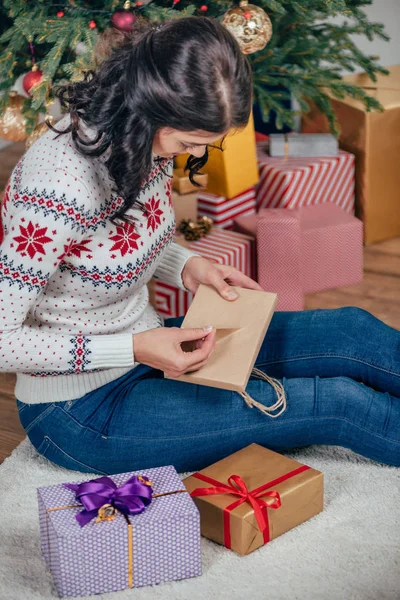 Woman unpacking christmas gift — Stock Photo