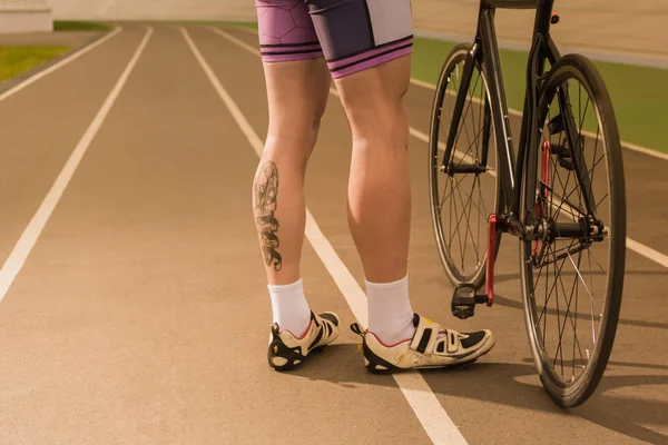 Cyclist standing near bicycle — Stock Photo