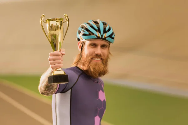 Cyclist with champion cup — Stock Photo