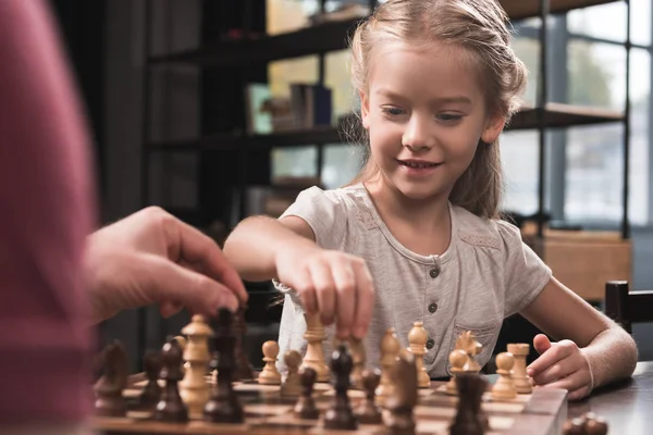 Preschooler kid playing chess — Stock Photo