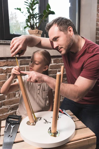 Father and daughter repairing table — Stock Photo