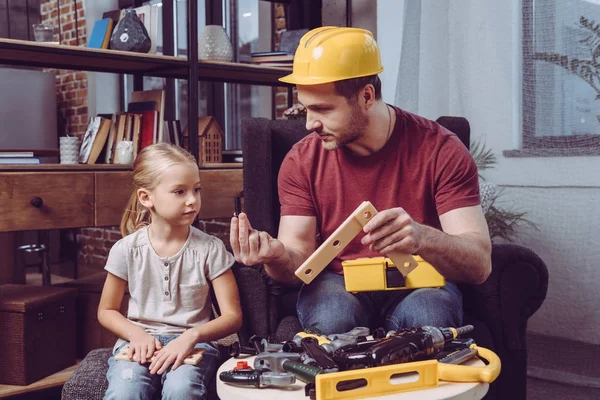 Father showing how make wooden frame — Stock Photo