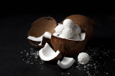 Siyah arka planda pişirilmiş hindistan cevizi sütü şekerleri, hindistan cevizli tatlı için malzemeler, Hindistan cevizli tatlı ürünler.