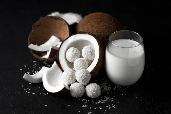 cooked coconut milk candies on a black dark background, coconut products, cocktail, yogurt, cream in a glass