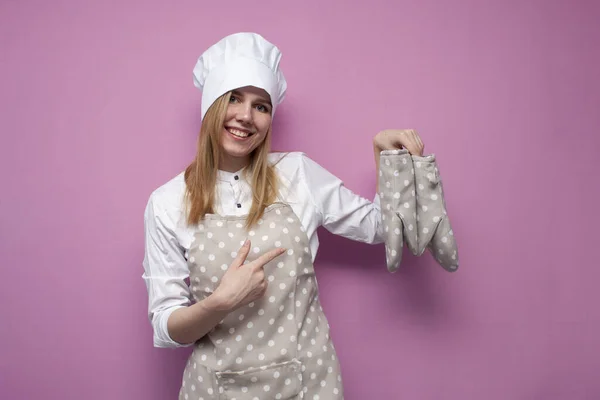 Happy Girl Cook Uniform Holds Baking Gloves Shows Finger Them — Stock Photo, Image