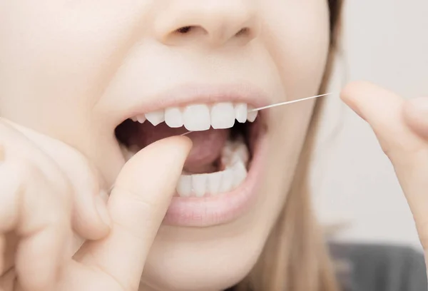 Dental floss in mouth, dental care