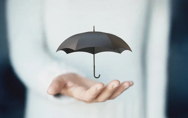 Umbrella on hands, concept of insurance or rain