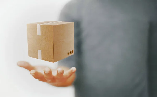 Hand with cartboard box, shipping or mail — Stock Photo, Image