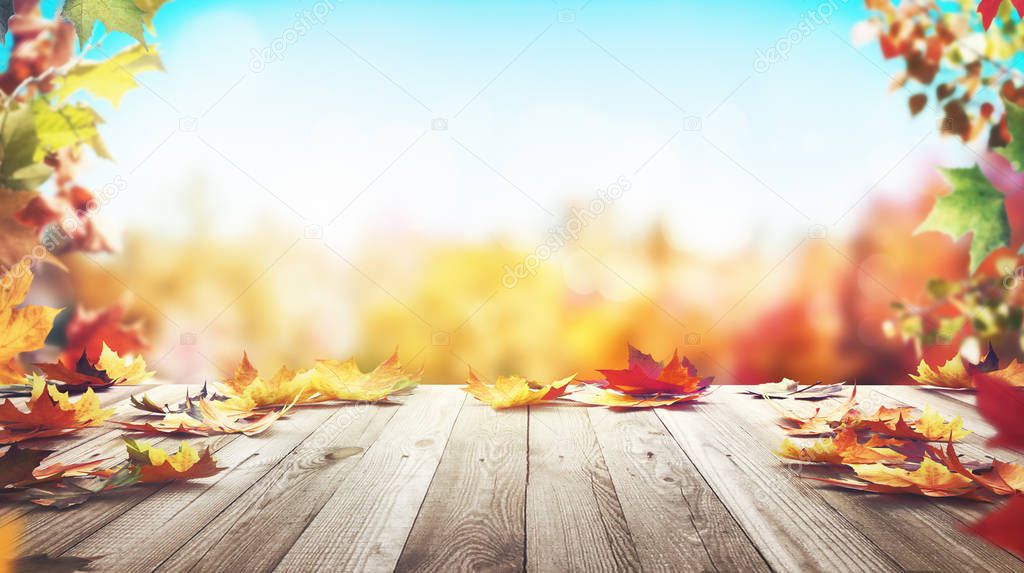 Autumn maple leaves on wooden table front. Falling leaves natural light warm background. 3d rendering